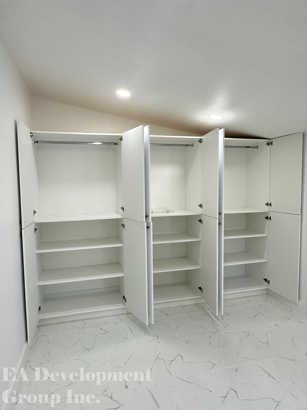 Custom reach-in closets with shelving, rods, and open doors