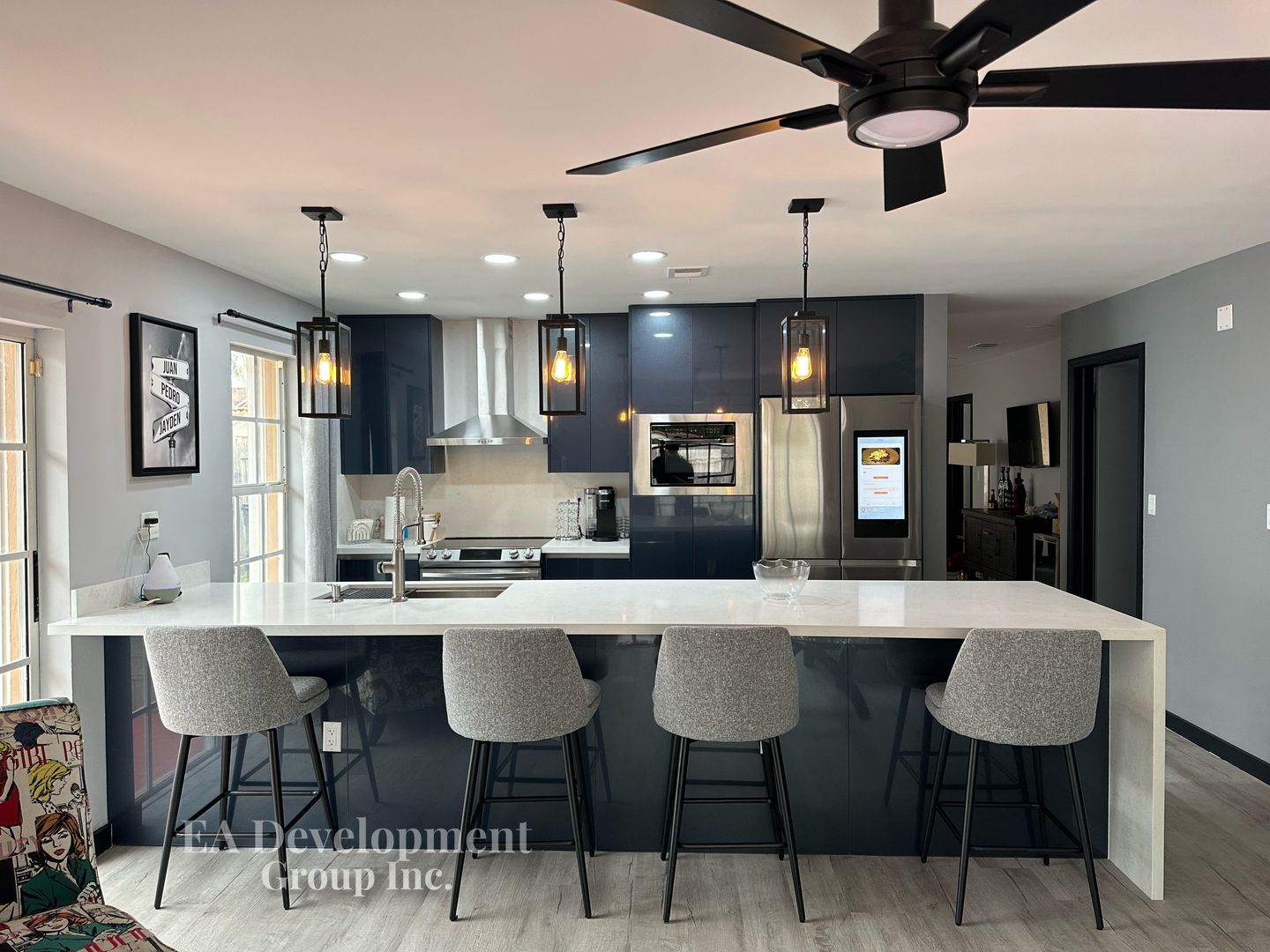 Kitchen renovation after — navy cabinetry with island, view 1