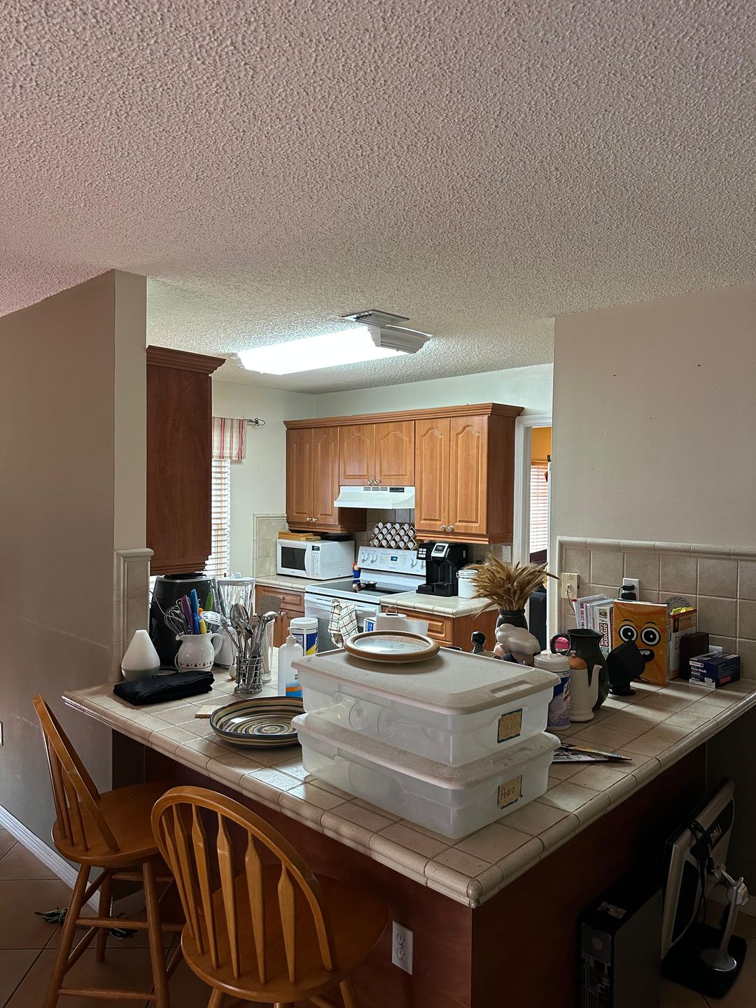 Kitchen renovation before — original wood cabinetry, view 1