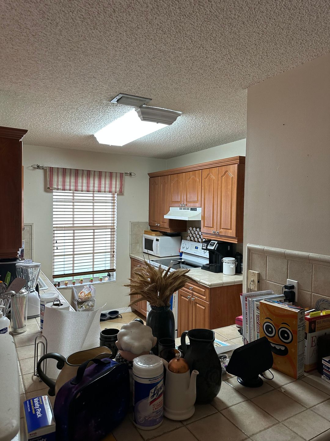 Kitchen renovation before — original wood cabinetry, view 2