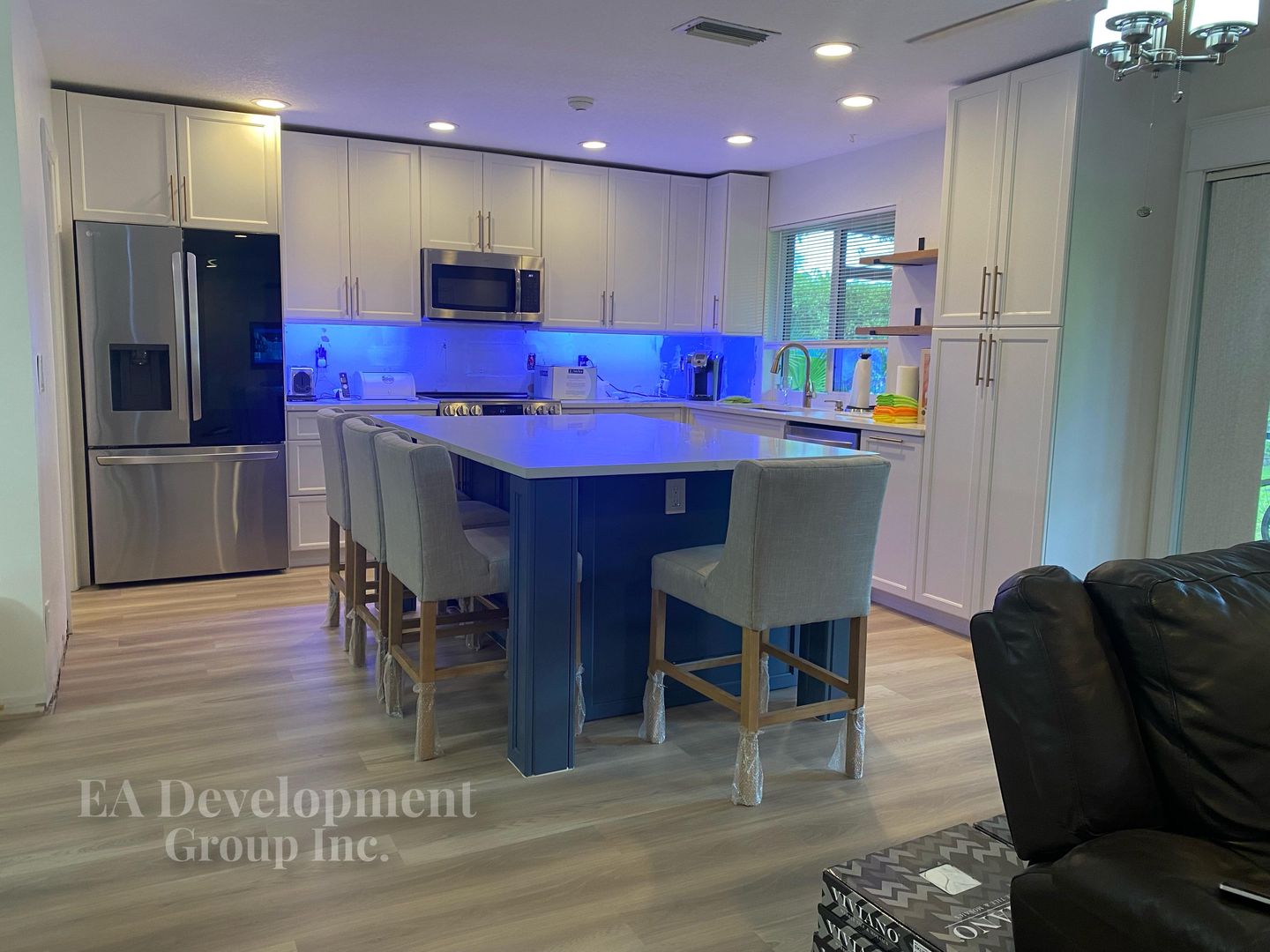 Kitchen renovation after — mosaic backsplash and island lighting detail