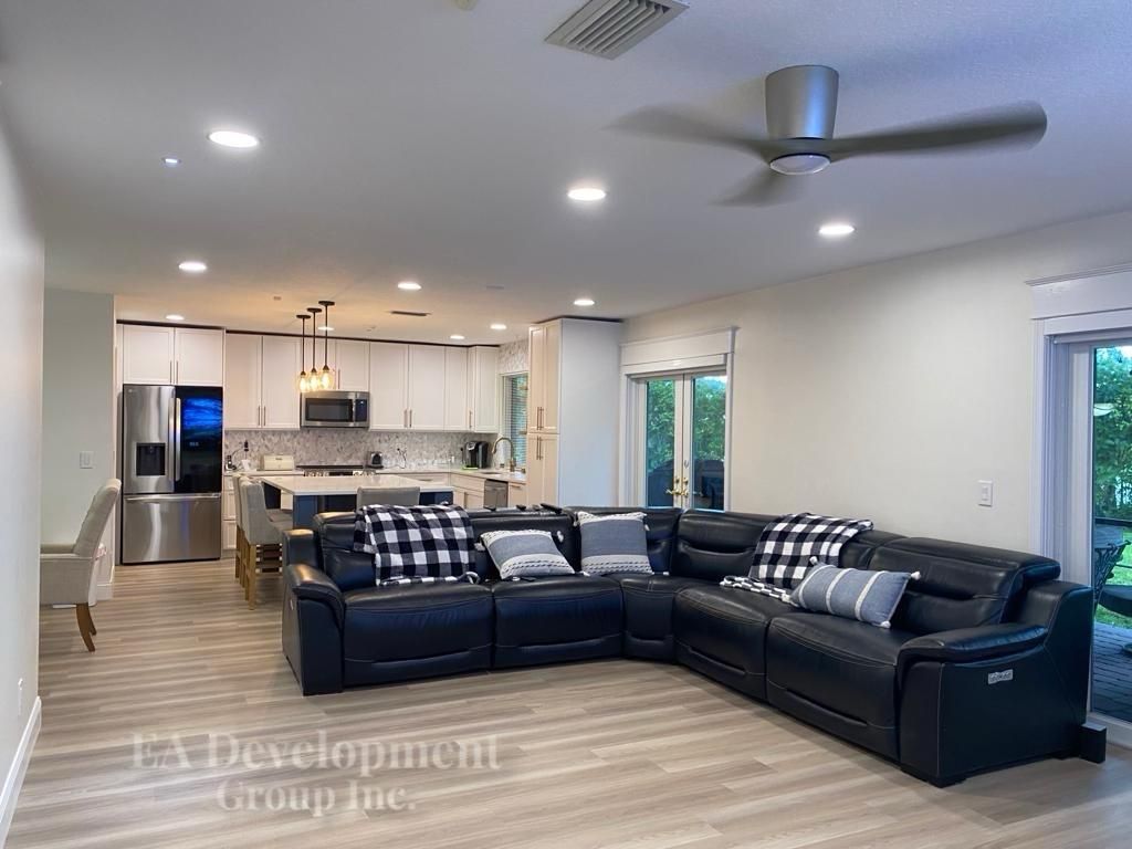 Kitchen renovation after — open-concept view from the living room