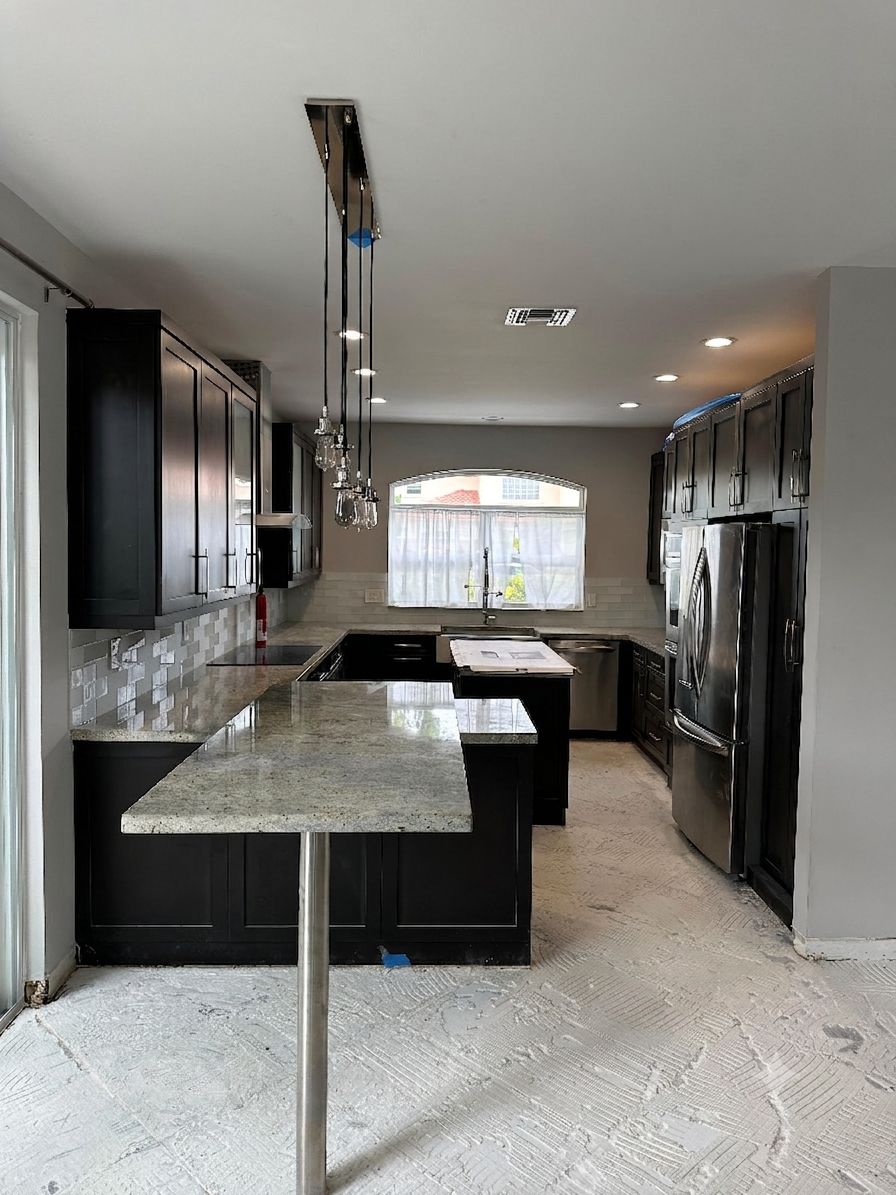 Kitchen renovation before — original dark galley kitchen with pendant lighting, mid-demo