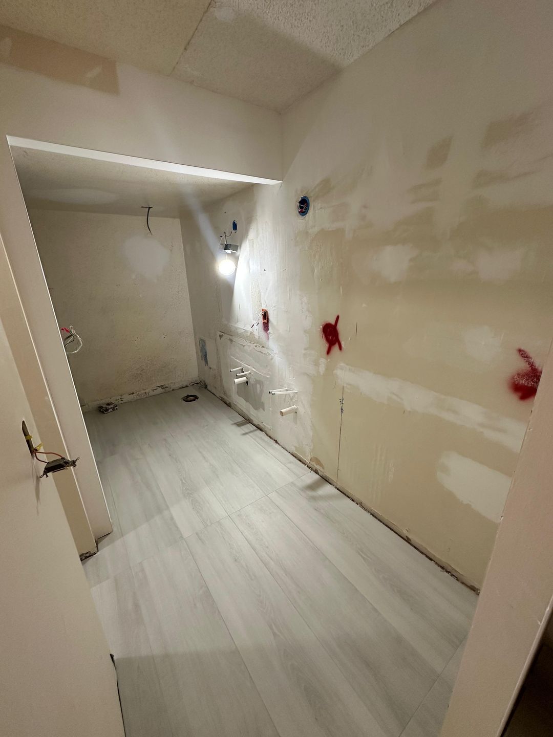 Bathroom renovation before — gutted bathroom down to drywall