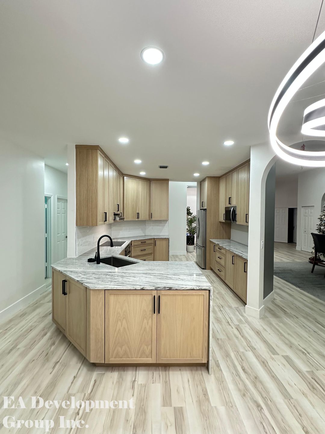 Kitchen renovation after — oak kitchen with round pendant lighting